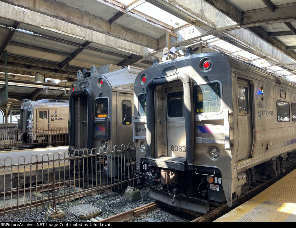 NJT Comet V Cab Car on the left, a Multilevel Cab Car in the middle, and a NJT Comet V Cab Car on the far right